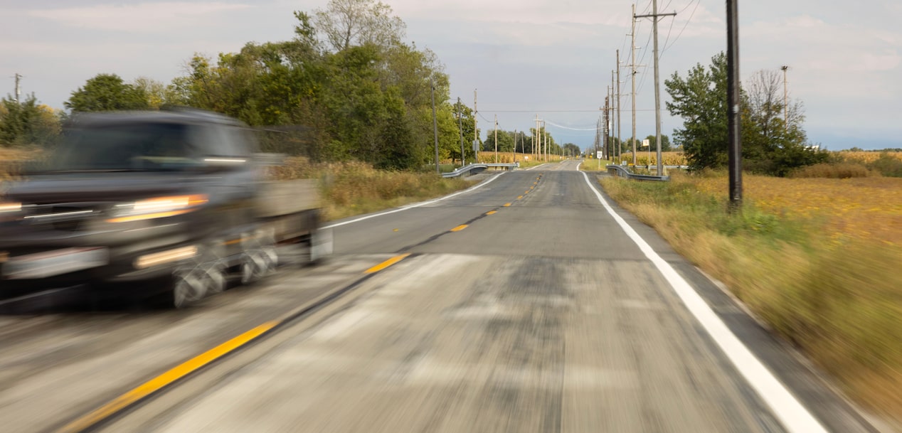 A vehicle speeding down a road.