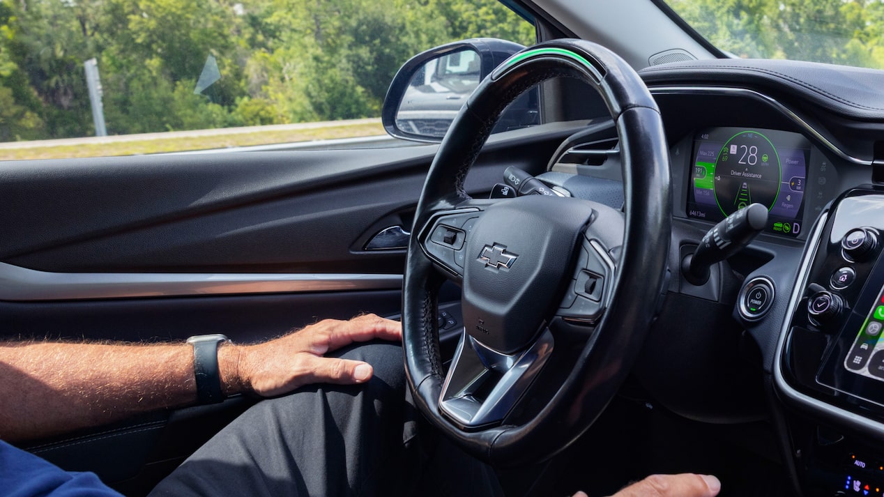 Mark P. drives his Chevrolet Bolt EUV with his hands in his lap, the steering wheel illuminated green for active Super Cruise.
