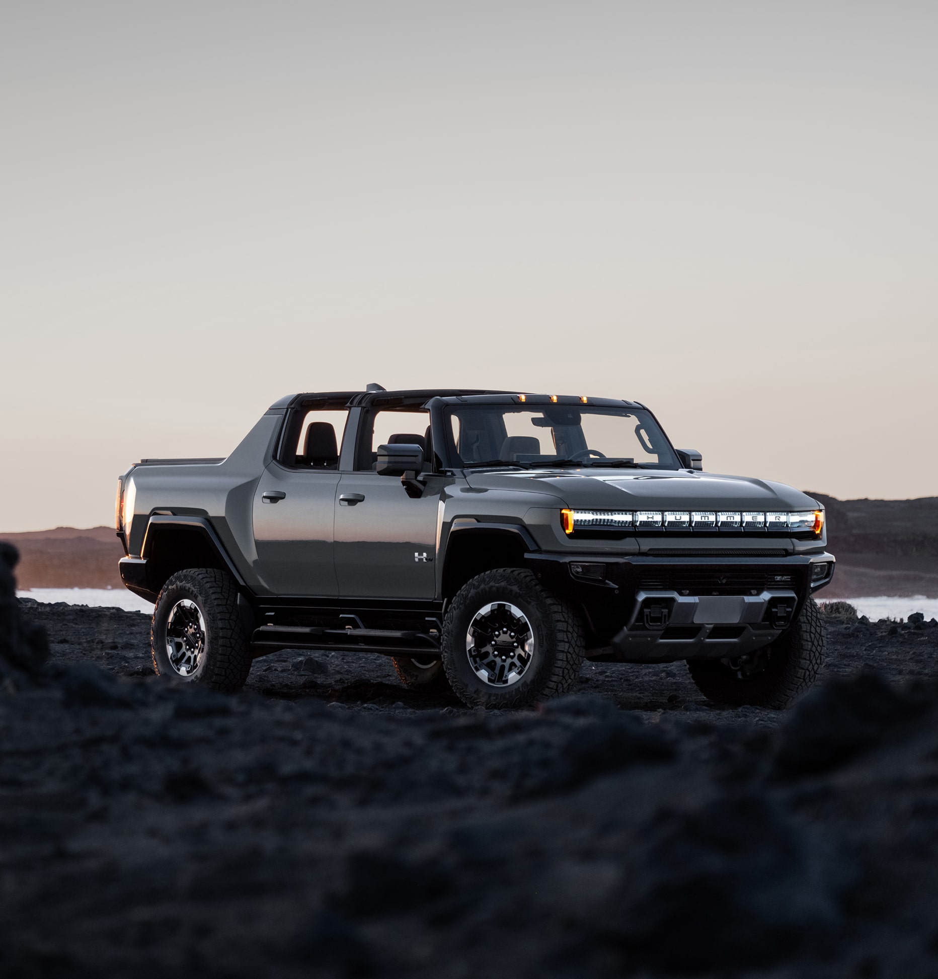 Hummer EV body shot with mountains/sunset