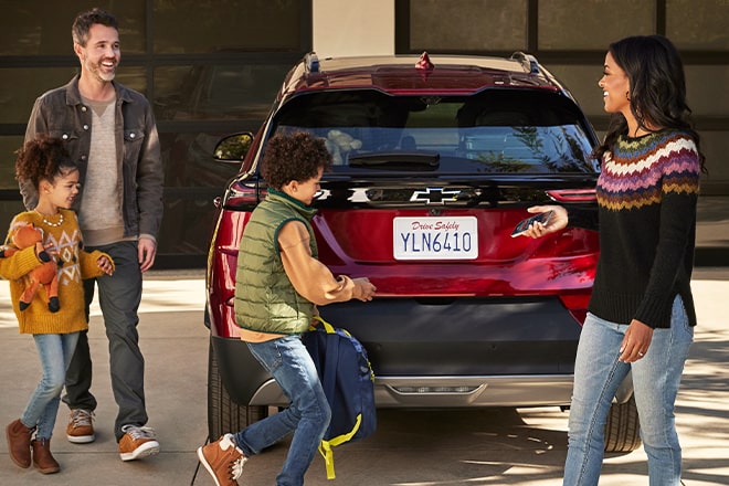 A family getting in their vehicle for a road trip