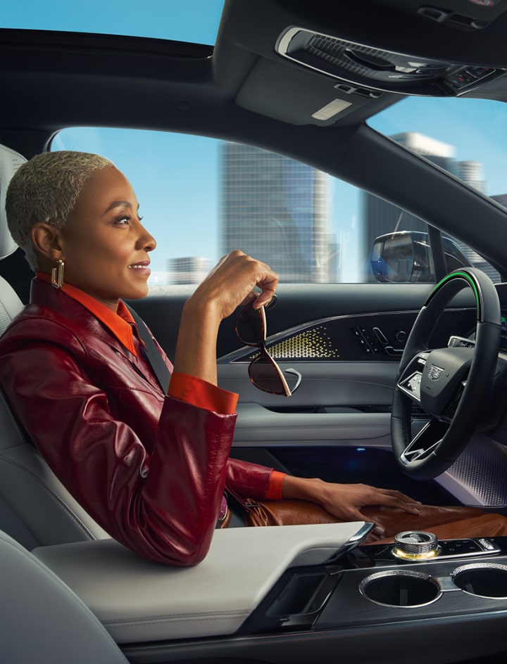 Super Cruise woman holding sunglasses in vehicle