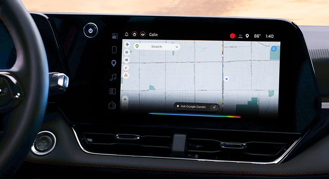 A car's infotainment screen displays Google Maps with a route selected.