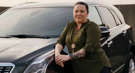 Women Leaning onto Hood of GM Vehicle 