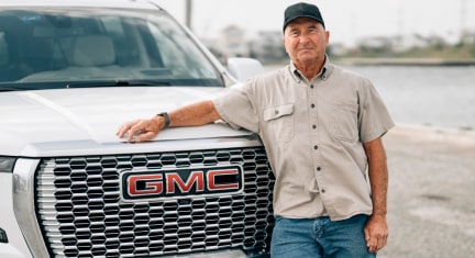 Bruce Dawson Leaning Against GMC Yukon