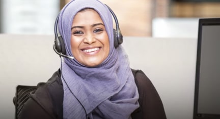 Female OnStar Advisor Smiling at the Camera