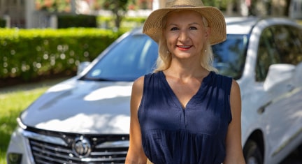 Woman wearing a hat walking down the road