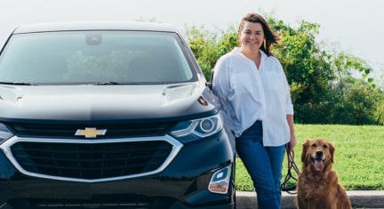 MISSING. SUGGESTION: Woman leaning on Chevy car with dog