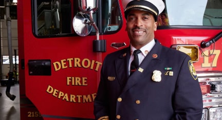 Fire Chief Smiling Standing in front of Fire Truck