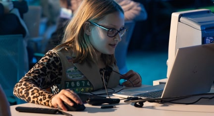 A young Girl Scout using a computer