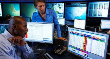 Command Center Workers Manage Rescue Resources on Desktop