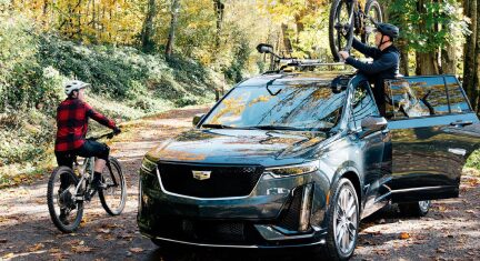 Preparing for a Bike Trip next to Cadillac SUV