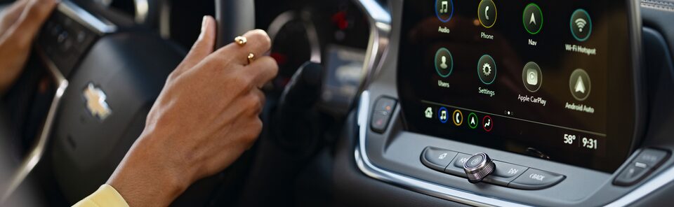 A woman driving with her in-vehicle apps powered on.