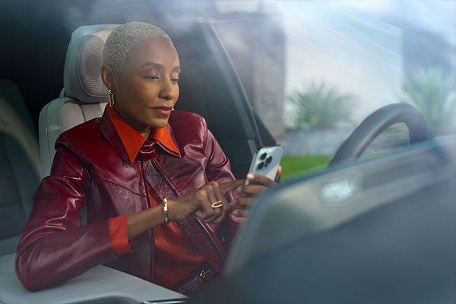A woman using her smartphone to use OnStar remote commands