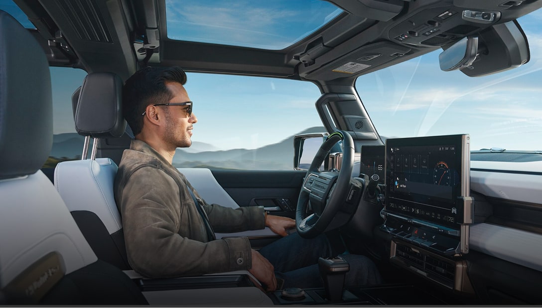 A side view of a gentleman in the driver's seat utilizing Super Cruise.