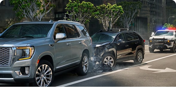 Two SUVS in a rear ending accident and a police vehicle behind them with its lights on.