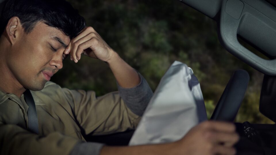 Man in Car Accident Rests Head on Hand
