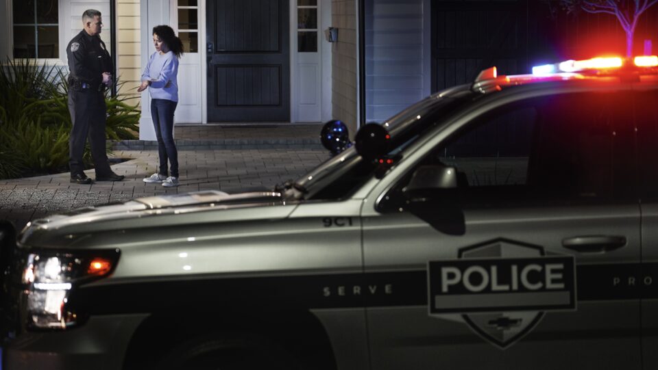 Police Car in Front of House
