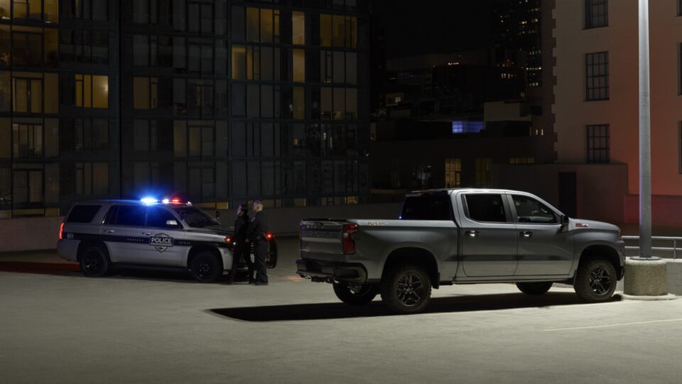 Truck in Parking Lot Next to Police Car