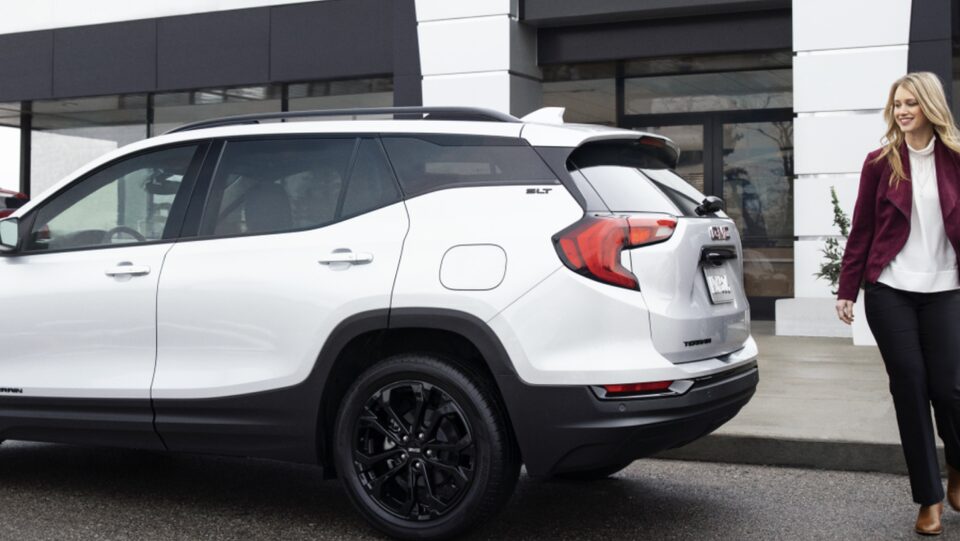 Woman Walking Behind SUV