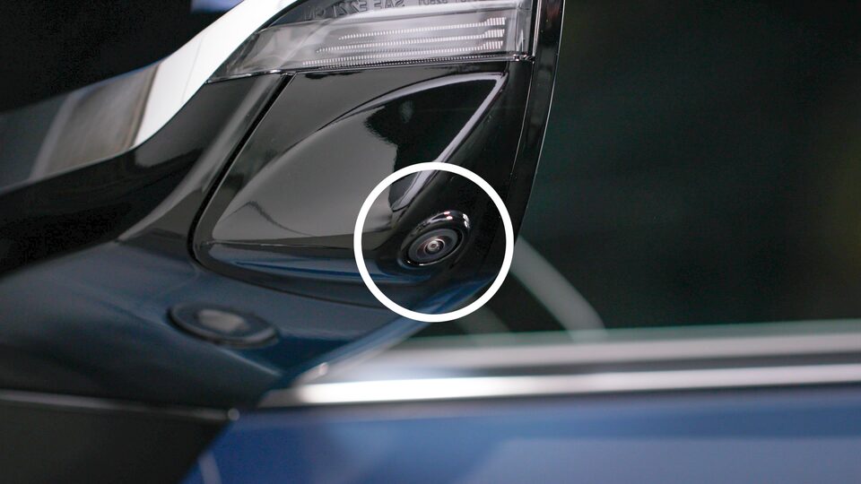 Close-up of the vehicle's driver side mirror camera