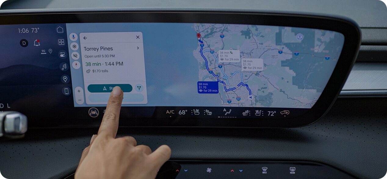 Hand selecting a destination on the Google Maps dashboard display with active route guidance.