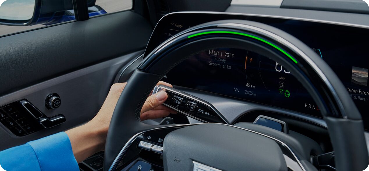 Light green Super Cruise indicator on the steering wheel while a turn signal is activated for a hands-free lane change.