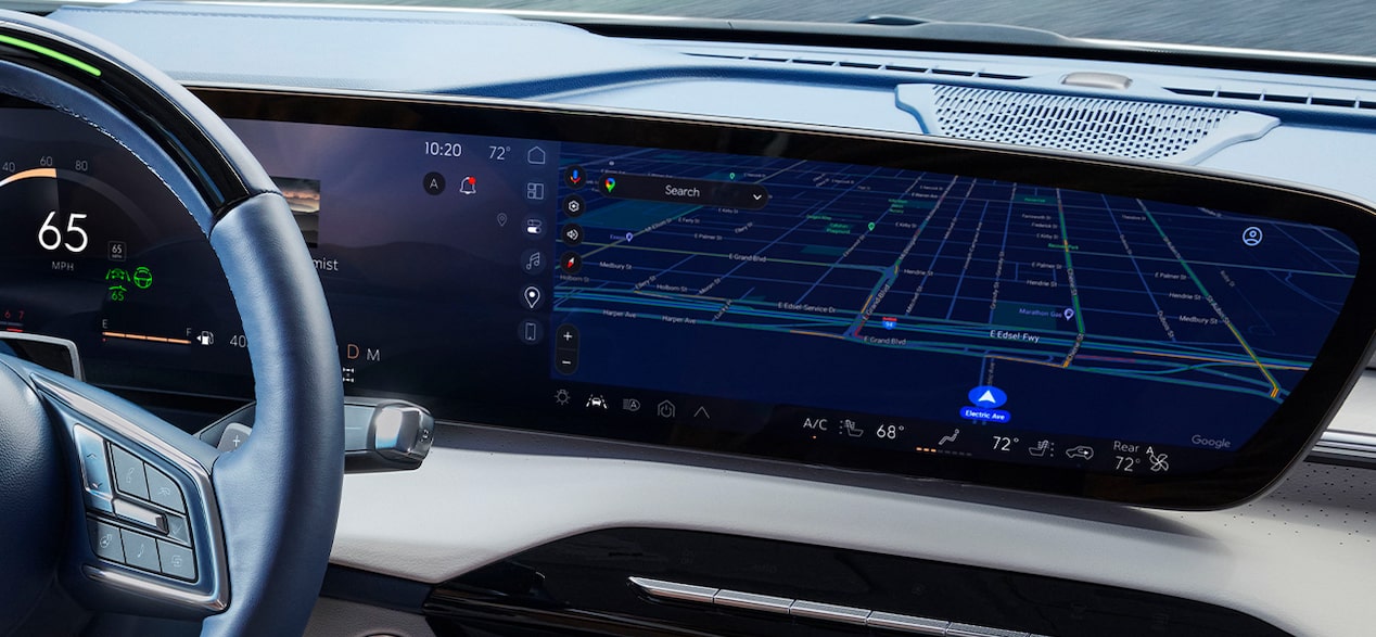 A driver's perspective shows a car's infotainment system displaying a detailed navigation map with a route.