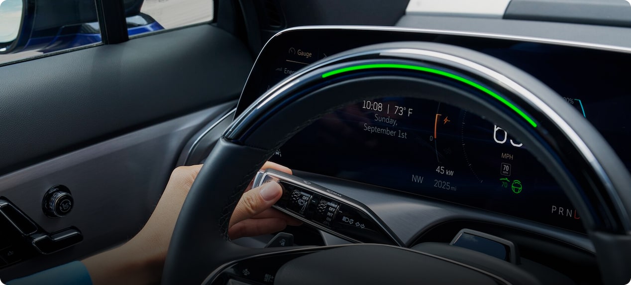 Light green Super Cruise indicator on the steering wheel showing hands-free driving is active while a driver activates the turn signal to initiate a vehicle-completed lane change.