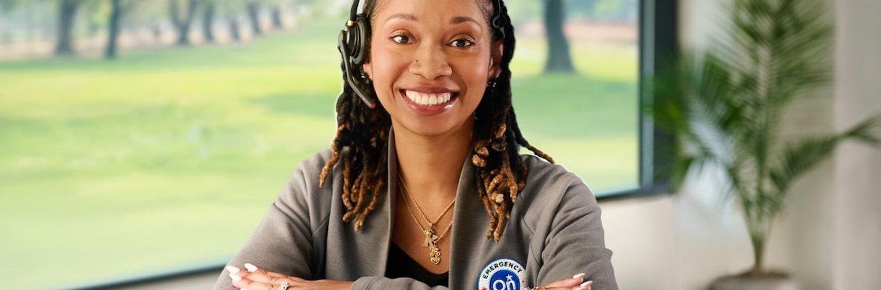 A female OnStar employee sitting with her arms crossed