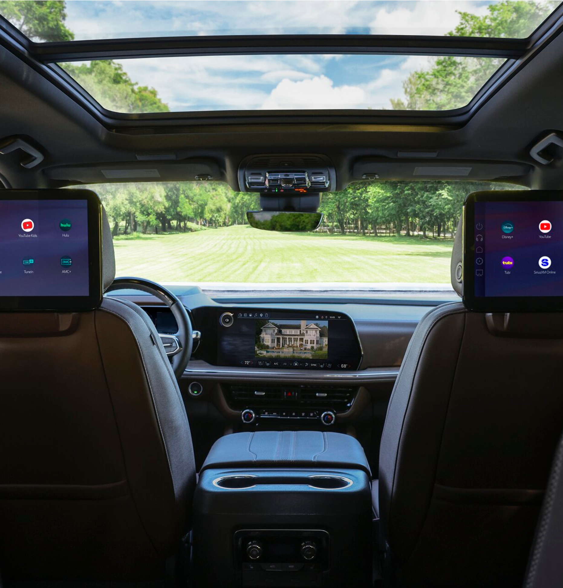 Dual rear-seat entertainment screens displaying streaming apps through OnStar Passenger Entertainment in a vehicle.