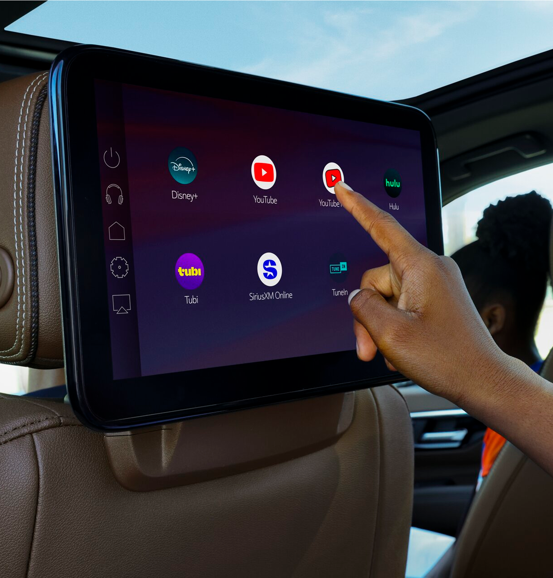 Rear-seat entertainment screen displaying YouTube, Disney+, Hulu and other streaming apps in an OnStar-equipped vehicle.