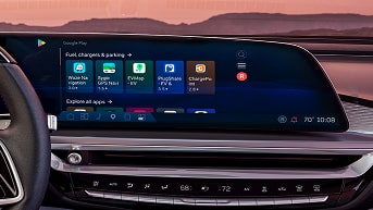 Infotainment System and Right Hand of Driver on Steering Wheel