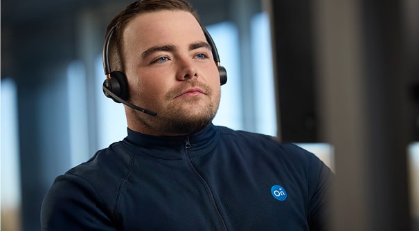 A Service Advisor Looking at a Monitor While Wearing a Headset
