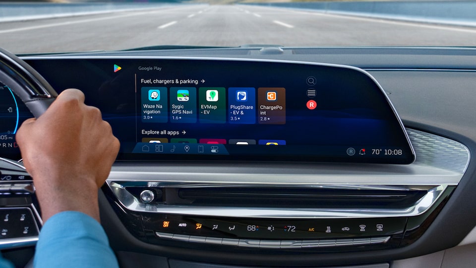 Infotainment System and Right Hand of Driver on Steering Wheel