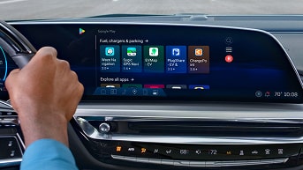 Infotainment System and Right Hand of Driver on Steering Wheel