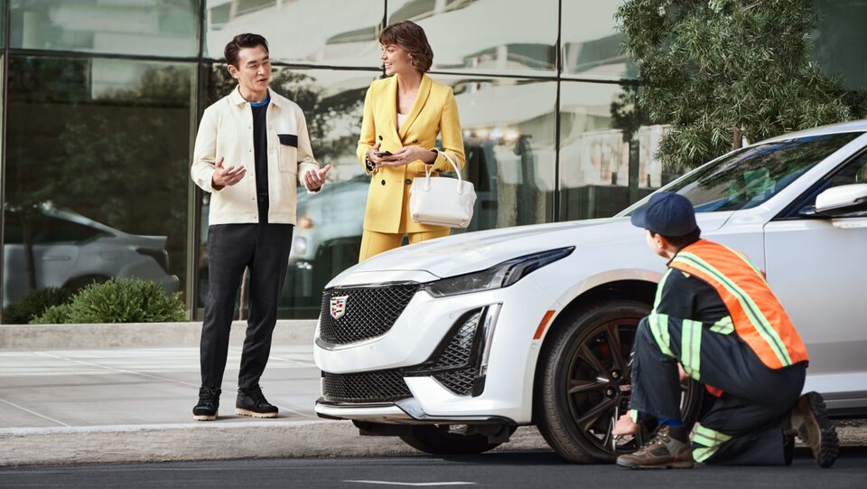 Roadside assistance worker assisting customers with their vehicle