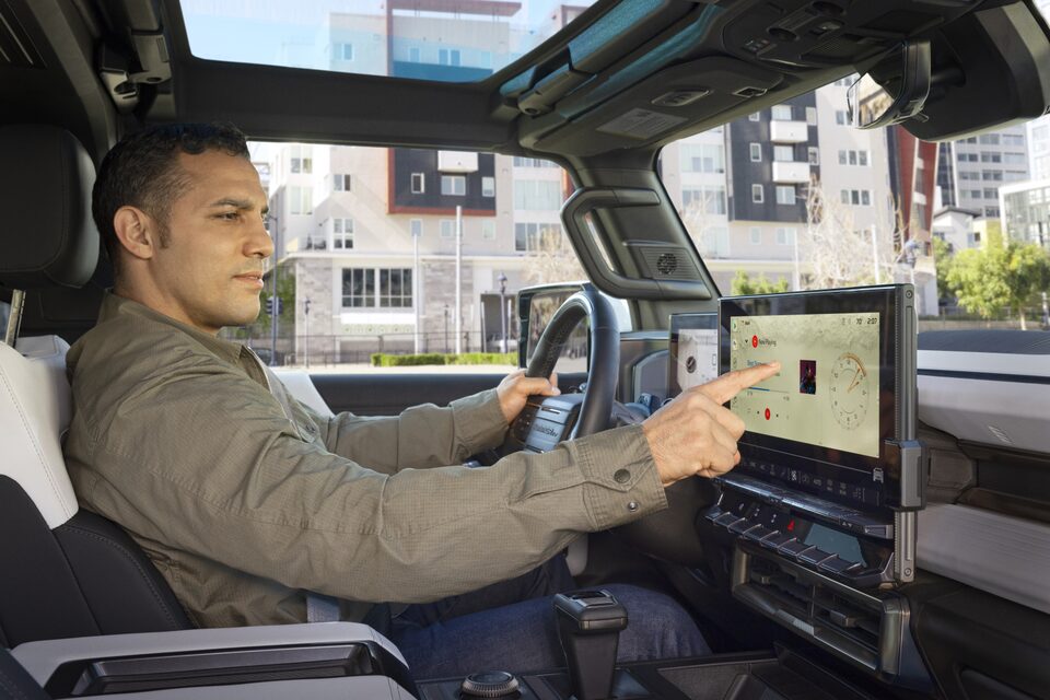 Male Driver Pressing His Infotainment Screen in His Vehicle