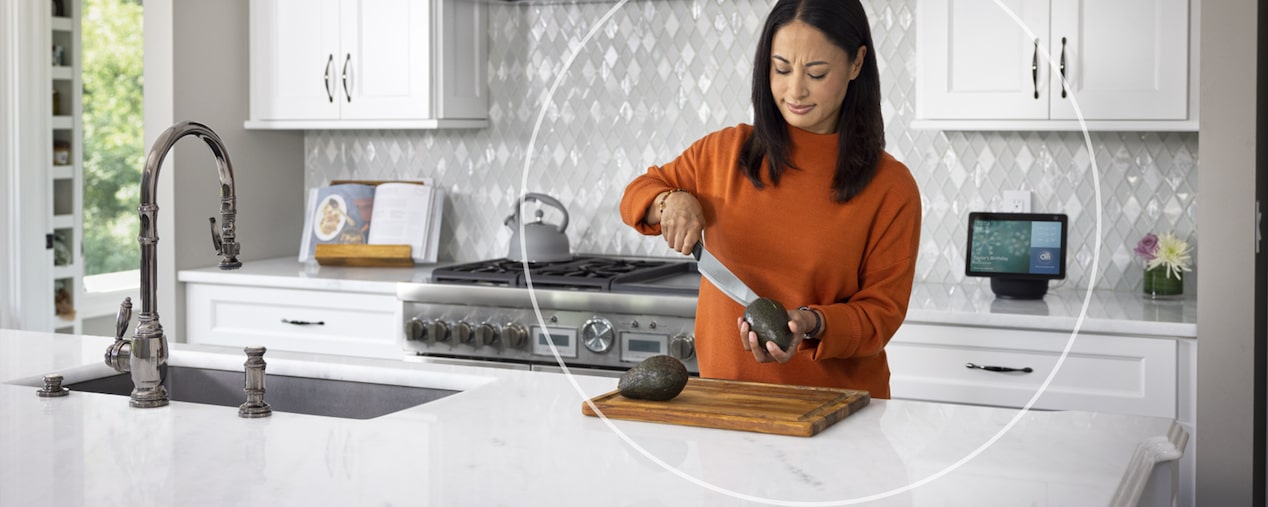 Woman Standing in Kitchen Cutting Avocados 