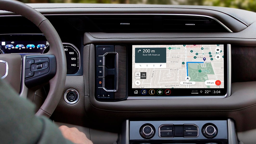 A backseat view of the infotainment screen with a map displayed on it.