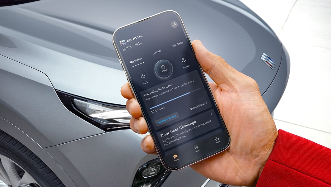 A man holding a smartphone displaying his vehicle's information.