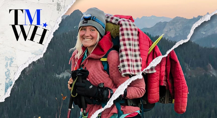 An image of a woman on top of a mountain with winter traveling gears next to the text overlay of "Tell Me What Happened". 