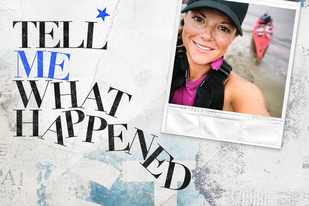 A woman taking a selfie wearing a black hat with a boat behind her next to the text overlay of "Tell Me What Happened".