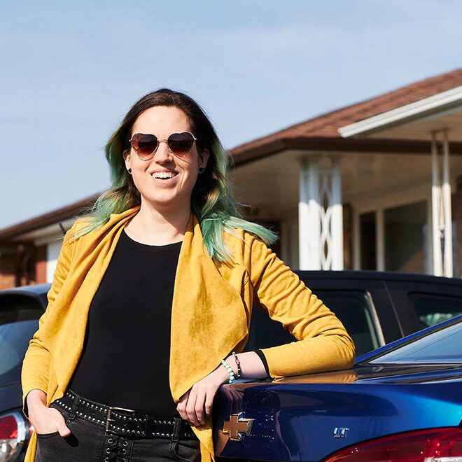 Women Leaning on Vehicle Smiling