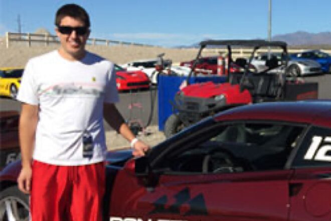 Wesley Irek Standing Next to a Race Car