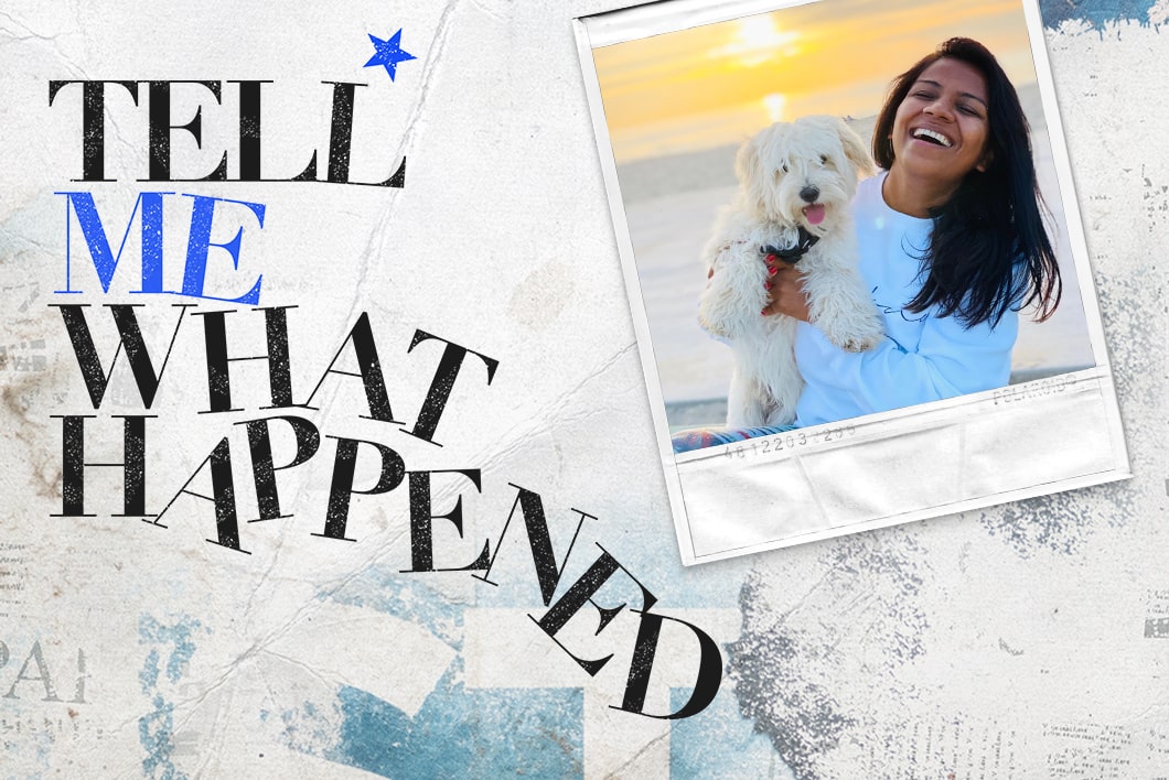 A woman laughing while carrying a dog in front of the beach next to the text overlay of "Tell Me What Happened".