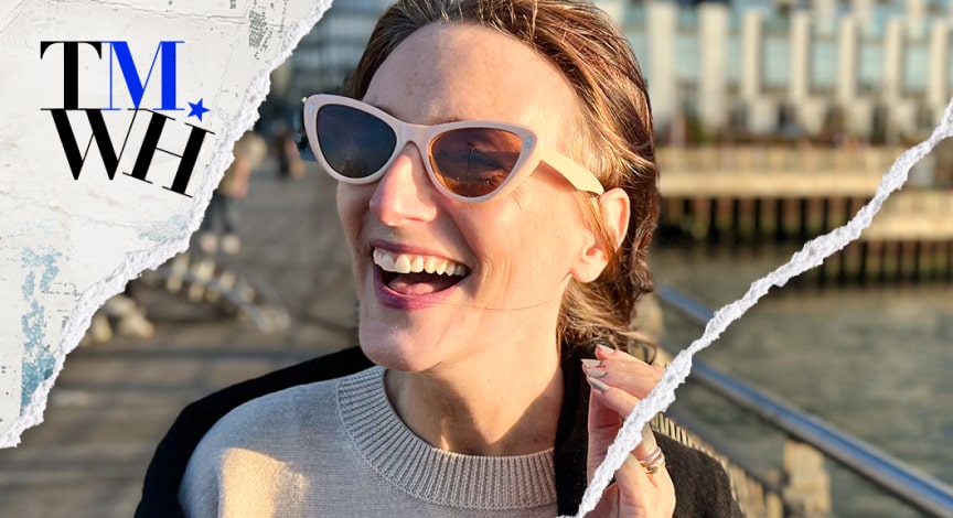 A girl smiling while wearing a sunglasses outside on a sunny day next to the text overlay of "Tell Me What Happened". 