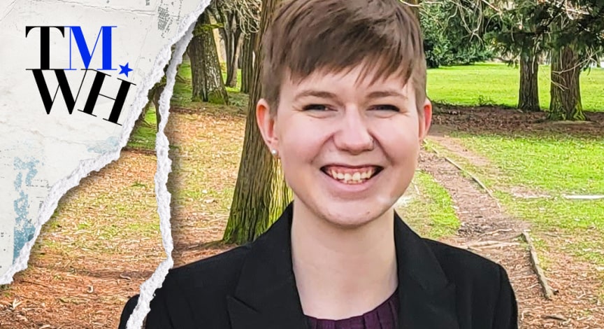 A girl with short hair smiling.