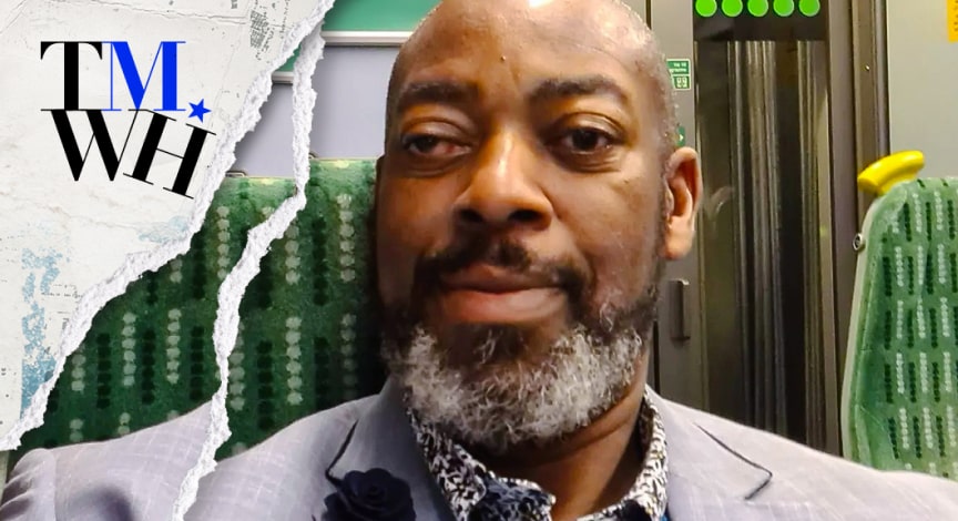A man with a grey beard in a suit.