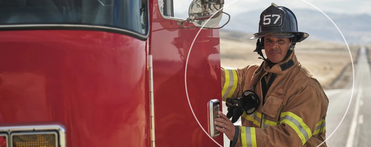 Firefighter Smiling and Entering Fire Truck in their Gear