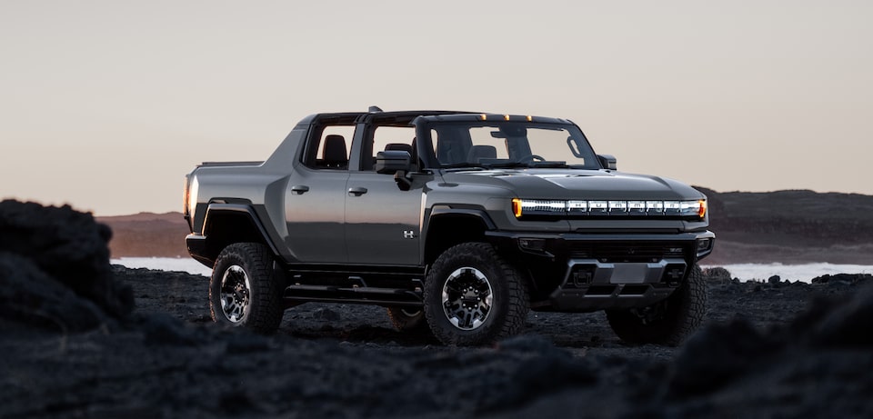 Hummer EV body shot with mountains/sunset